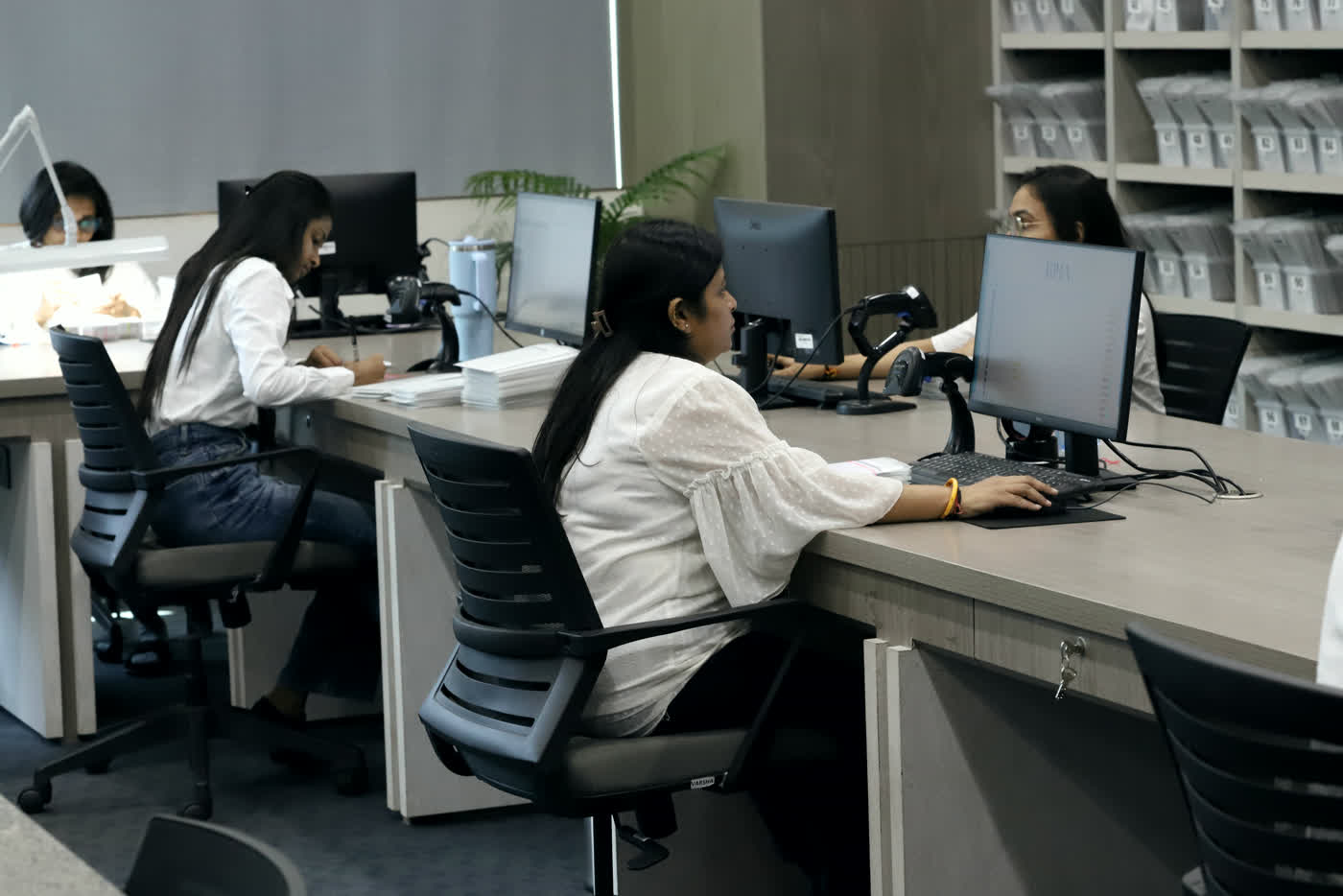 Women on the KIRA service team at their desks