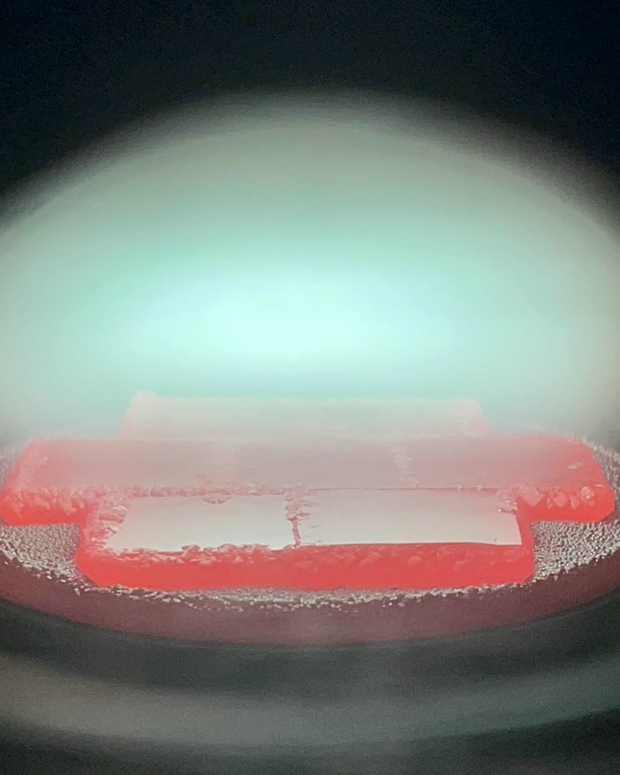 Orange glow of a diamond seed growing in plasma